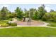 Community playground surrounded by lush greenery, walking paths and benches at 5723 S Union Ct, Littleton, CO 80127