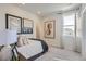Bright bedroom with neutral colors, carpet flooring, and modern decor, illuminated by natural light through a large window at 14147 Bunny Hop Ln, Parker, CO 80134