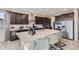 Stylish kitchen featuring dark cabinets, a large center island with seating, and stainless steel appliances at 14147 Bunny Hop Ln, Parker, CO 80134