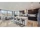Open-concept kitchen featuring a large island with bar seating and stainless steel appliances in a modern design at 14147 Bunny Hop Ln, Parker, CO 80134
