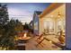 Beautiful backyard featuring a fire pit, patio seating, and a glimpse of the home's exterior and interior lighting at 14582 Mission Walk Loop, Parker, CO 80134