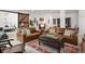 Inviting basement seating area with a comfortable sofa, vibrant rug, and rustic barn door at 14582 Mission Walk Loop, Parker, CO 80134