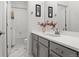 Bright bathroom with gray vanity, modern fixtures, and a bathtub with shower at 14582 Mission Walk Loop, Parker, CO 80134