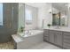 Modern bathroom featuring a soaking tub and glass-enclosed shower with pebble floor detail at 14582 Mission Walk Loop, Parker, CO 80134