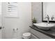 Elegant powder room with a stylish sink and a decorative mirror at 14582 Mission Walk Loop, Parker, CO 80134