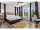 Bright bedroom with large windows, hardwood floors, and a comfortable bed at 14582 Mission Walk Loop, Parker, CO 80134