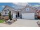 Well-maintained home featuring a two-car garage, landscaped front yard, and a mix of siding and brick accents at 14582 Mission Walk Loop, Parker, CO 80134