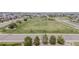 Large green space surrounded by residential homes and roads in the community at 14582 Mission Walk Loop, Parker, CO 80134