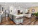Open concept kitchen with a center island, stainless steel appliances, and a seamless flow to the living space at 14582 Mission Walk Loop, Parker, CO 80134