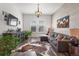 Cozy living room with a sectional sofa, hardwood floors, a wood accent wall, and natural lighting at 14582 Mission Walk Loop, Parker, CO 80134
