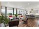Open-concept design living room flows into the modern kitchen with island and dining area at 14582 Mission Walk Loop, Parker, CO 80134