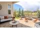 Charming outdoor patio with a stone fire pit, comfortable seating, and scenic views at 14582 Mission Walk Loop, Parker, CO 80134
