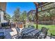 Backyard with outdoor kitchen and outdoor seating area with a well manicured lawn at 10694 Cedarcrest Cir, Highlands Ranch, CO 80130