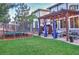 Backyard features a trampoline, pergola-covered patio with outdoor seating and well-manicured lawn at 10694 Cedarcrest Cir, Highlands Ranch, CO 80130