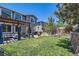 Spacious backyard with pergola-covered patio, outdoor kitchen, and well-manicured lawn at 10694 Cedarcrest Cir, Highlands Ranch, CO 80130