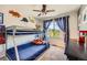 This cozy bedroom features a bunk bed and a lovely window with natural light and decorative curtains at 10694 Cedarcrest Cir, Highlands Ranch, CO 80130