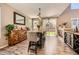 Bright dining area featuring a wooden table, stylish chairs, and backyard access at 10694 Cedarcrest Cir, Highlands Ranch, CO 80130