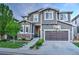 Two story home with gray siding, a two car garage and a basketball hoop above it at 10694 Cedarcrest Cir, Highlands Ranch, CO 80130