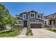 Charming two-story home with a well-manicured front yard and attached two-car garage at 10694 Cedarcrest Cir, Highlands Ranch, CO 80130