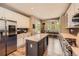 Modern kitchen features a center island, stainless appliances and eat-in nook with a view of the backyard at 10694 Cedarcrest Cir, Highlands Ranch, CO 80130