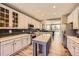 Bright kitchen features white cabinets, stainless appliances, a center island and a modern backsplash at 10694 Cedarcrest Cir, Highlands Ranch, CO 80130