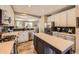 Bright kitchen boasts a gas range, stainless appliances and a large island with quartz countertop at 10694 Cedarcrest Cir, Highlands Ranch, CO 80130
