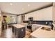 Well-lit kitchen with white cabinets, stainless steel appliances, an island, and a dining area at 10694 Cedarcrest Cir, Highlands Ranch, CO 80130