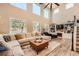 Expansive living room with large windows, high ceilings, modern decor, and a cozy fireplace at 10694 Cedarcrest Cir, Highlands Ranch, CO 80130