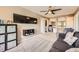 Spacious entertainment room features large screen TV, mounted shelving, and access to office and open area at 10694 Cedarcrest Cir, Highlands Ranch, CO 80130