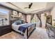 Cozy main bedroom with tray ceiling, accent wall, carpet, and large window overlooking the backyard at 10694 Cedarcrest Cir, Highlands Ranch, CO 80130
