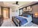Spacious main bedroom with tray ceiling, accent wall, carpet, and ample closet space at 10694 Cedarcrest Cir, Highlands Ranch, CO 80130