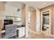 This upstairs office features built-in desk, white cabinets, and hallway access to other rooms in the house at 10694 Cedarcrest Cir, Highlands Ranch, CO 80130