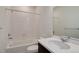 Clean bathroom features a shower-tub combo and single vanity with a dark wood cabinet at 3961 Happy Hollow Dr, Castle Rock, CO 80104