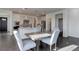 Dining area featuring a modern table set and pendant lighting, adjacent to an open-concept kitchen at 3961 Happy Hollow Dr, Castle Rock, CO 80104