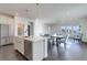 Open-concept kitchen, dining, and living space with stainless steel appliances and modern finishes and lots of natural light at 3961 Happy Hollow Dr, Castle Rock, CO 80104