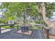 A shaded outdoor deck with an outdoor dining table set is perfect for enjoying outdoor meals and entertaining at 7112 S Platte Canyon Dr, Littleton, CO 80128