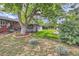 A spacious backyard with a deck, mature trees and lush lawn offers endless possibilities for outdoor enjoyment at 7112 S Platte Canyon Dr, Littleton, CO 80128