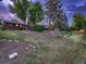 Large backyard with mature trees and potential garden area at 7112 S Platte Canyon Dr, Littleton, CO 80128