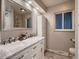 Bright bathroom features a double sink vanity, large mirror and a shower at 7112 S Platte Canyon Dr, Littleton, CO 80128