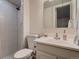 Bathroom with a tiled shower, updated vanity, toilet, and tile floors at 7112 S Platte Canyon Dr, Littleton, CO 80128