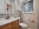 Updated bathroom featuring tile backsplash, a new mirror and a new vanity at 7112 S Platte Canyon Dr, Littleton, CO 80128