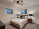 Comfortable bedroom featuring two large windows and a modern ceiling fan at 7112 S Platte Canyon Dr, Littleton, CO 80128