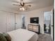 Bedroom featuring a ceiling fan, tv, closet and an ensuite bathroom at 7112 S Platte Canyon Dr, Littleton, CO 80128