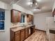 Well-lit kitchen featuring wooden cabinets, laminate countertops, and modern appliances at 7112 S Platte Canyon Dr, Littleton, CO 80128