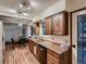 Bright eat-in kitchen with wooden cabinets, modern dishwasher, and view to dining area at 7112 S Platte Canyon Dr, Littleton, CO 80128