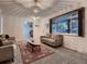 Bright living room featuring a large window, comfortable seating, and a decorative rug at 7112 S Platte Canyon Dr, Littleton, CO 80128
