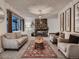 Spacious living room featuring a stone fireplace, neutral furniture, and ample natural light at 7112 S Platte Canyon Dr, Littleton, CO 80128