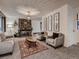 Cozy living room with a stone fireplace, chandelier, and stylish furniture at 7112 S Platte Canyon Dr, Littleton, CO 80128