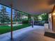 Covered patio with concrete floor, outdoor seating, lush lawn, and garden area at 7112 S Platte Canyon Dr, Littleton, CO 80128