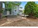 Back exterior featuring multiple decks, patio, mature landscaping, and lovely architectural design at 8056 Meadowdale Sq, Niwot, CO 80503